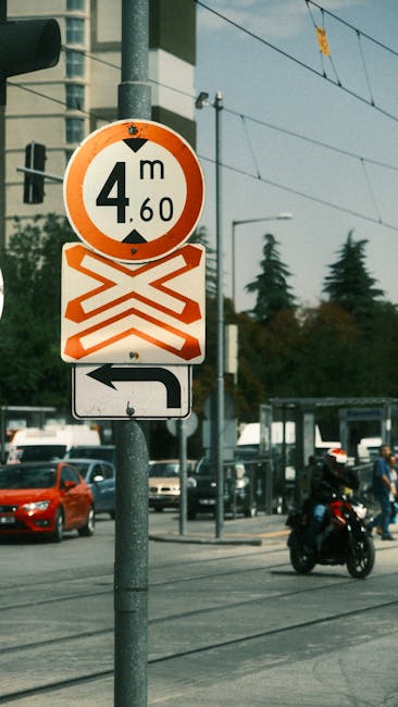 Traffic signs indicating height limits and direction