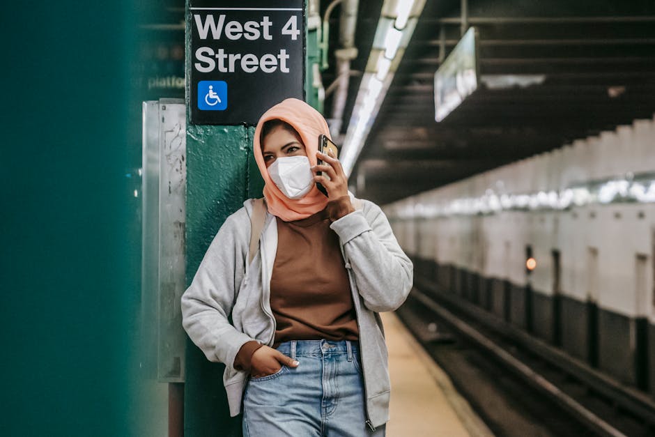 Woman using a smartphone in a modern urban transit station